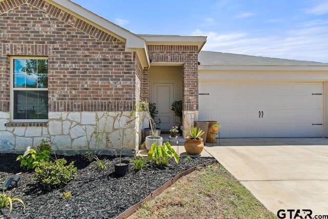 203 Parker Oaks Dr, Chandler, TX 75758 - view of front of house featuring brick siding, a garage, concrete driveway, and stone siding