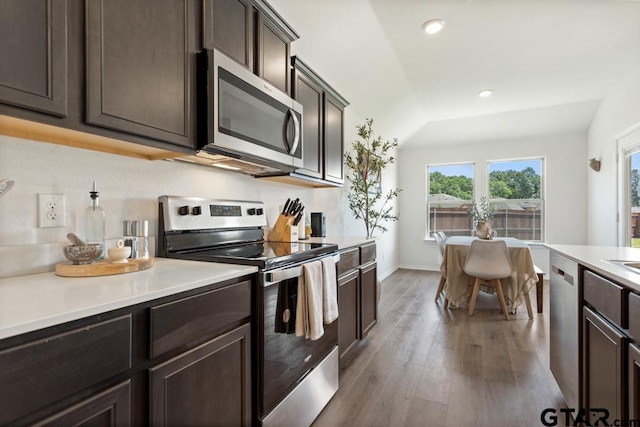 203 Parker Oaks Dr, Chandler, TX 75758 - kitchen featuring appliances with stainless steel finishes, wood finished floors, light countertops, dark brown cabinets, and recessed lighting