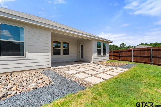 203 Parker Oaks Dr, Chandler, TX 75758 - rear view of house with a patio area and a fenced backyard