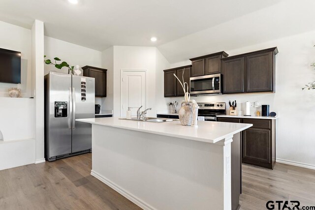 203 Parker Oaks Dr, Chandler, TX 75758 - kitchen featuring stainless steel appliances, light wood finished floors, dark brown cabinets, light countertops, and recessed lighting