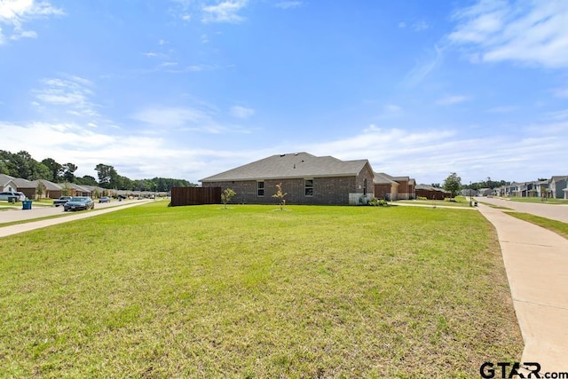 203 Parker Oaks Dr, Chandler, TX 75758 - view of side of property with a lawn, brick siding, and a residential view