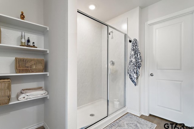 203 Parker Oaks Dr, Chandler, TX 75758 - bathroom featuring a shower stall and wood finished floors
