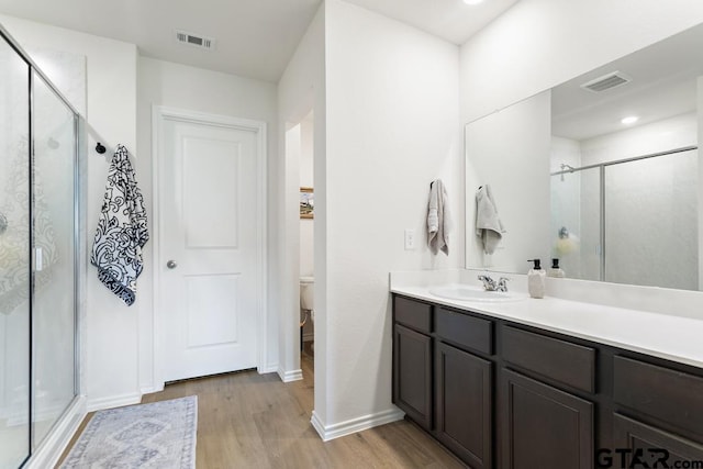 203 Parker Oaks Dr, Chandler, TX 75758 - bathroom with wood finished floors, a shower stall, and vanity