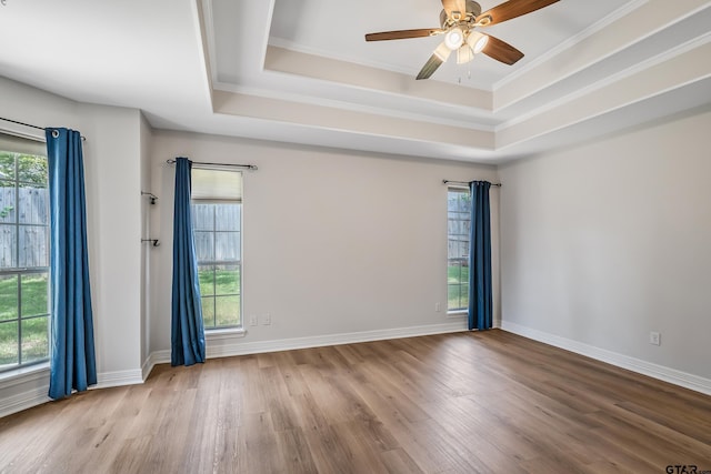 629 Whiteoak Ln, Tyler, TX 75703 - unfurnished room with a raised ceiling, wood finished floors, plenty of natural light, crown molding, and a ceiling fan