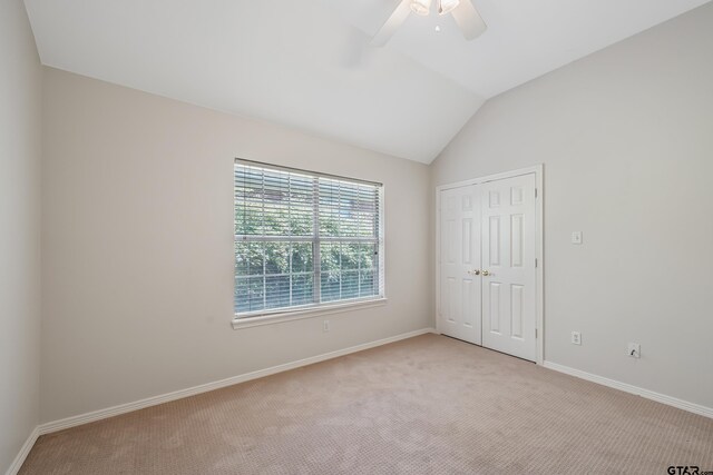 629 Whiteoak Ln, Tyler, TX 75703 - unfurnished bedroom featuring light carpet, a closet, lofted ceiling, and a ceiling fan
