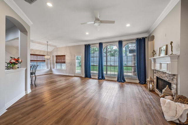 629 Whiteoak Ln, Tyler, TX 75703 - living room with a fireplace, a ceiling fan, ornamental molding, dark wood finished floors, and arched walkways