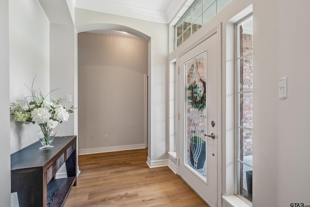 629 Whiteoak Ln, Tyler, TX 75703 - foyer with arched walkways, healthy amount of natural light, light wood-style floors, and crown molding