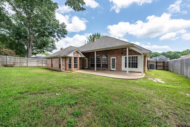 629 Whiteoak Ln, Tyler, TX 75703 - back of property with brick siding, a patio, a fenced backyard, and a chimney