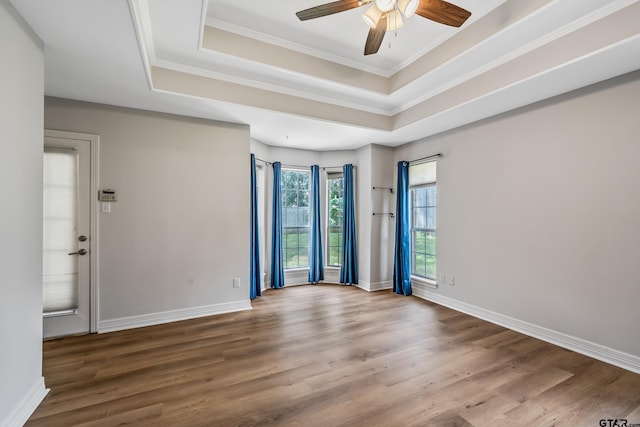629 Whiteoak Ln, Tyler, TX 75703 - unfurnished room featuring a raised ceiling, a ceiling fan, wood finished floors, and ornamental molding