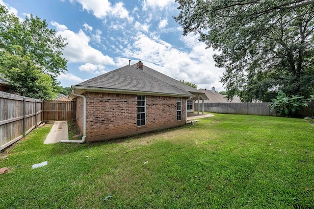 629 Whiteoak Ln, Tyler, TX 75703 - back of property featuring roof with shingles, brick siding, and a fenced backyard