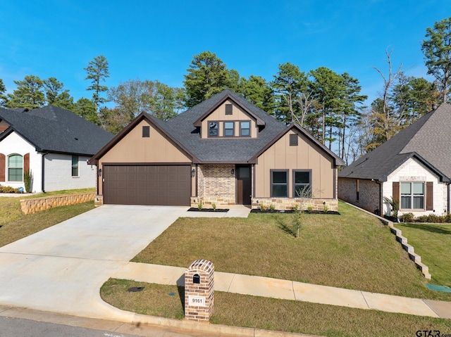 9161 Cave Branch Cv, Tyler, TX 75703 - view of front of house featuring board and batten siding, an attached garage, driveway, a front lawn, and roof with shingles