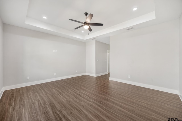 9161 Cave Branch Cv, Tyler, TX 75703 - spare room with a tray ceiling, a ceiling fan, recessed lighting, baseboards, and dark wood-style flooring