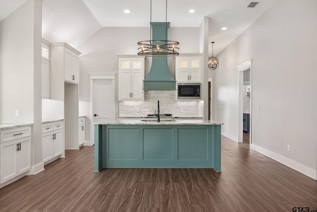 9161 Cave Branch Cv, Tyler, TX 75703 - kitchen featuring black microwave, a chandelier, custom exhaust hood, white cabinets, and dark wood finished floors