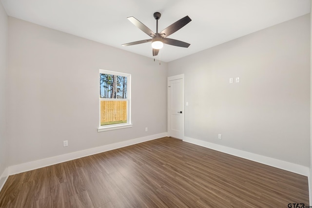 spare room with ceiling fan and dark wood-type flooring