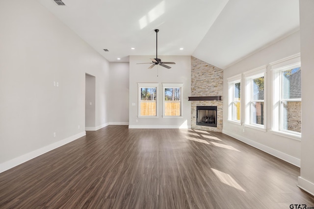 unfurnished living room featuring high vaulted ceiling, a stone fireplace, ceiling fan, and dark wood-type flooring