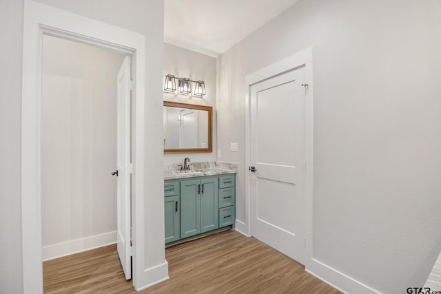 9161 Cave Branch Cv, Tyler, TX 75703 - bathroom with wood finished floors, vanity, and baseboards