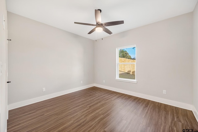 empty room with ceiling fan and dark wood-type flooring