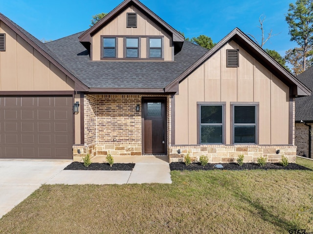 view of front of house featuring a front yard and a garage