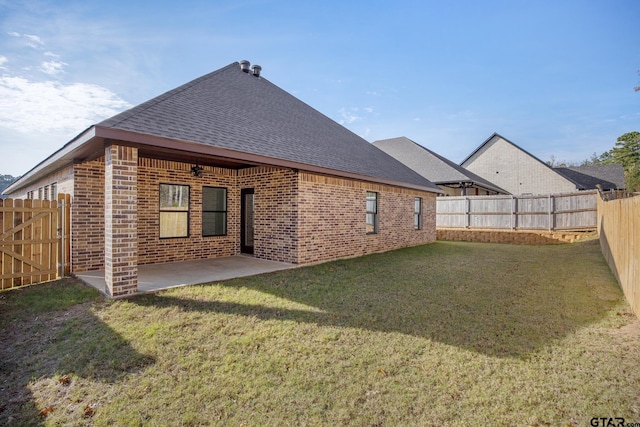 back of house featuring a patio area and a yard