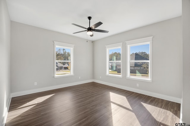 spare room featuring ceiling fan and dark hardwood / wood-style floors