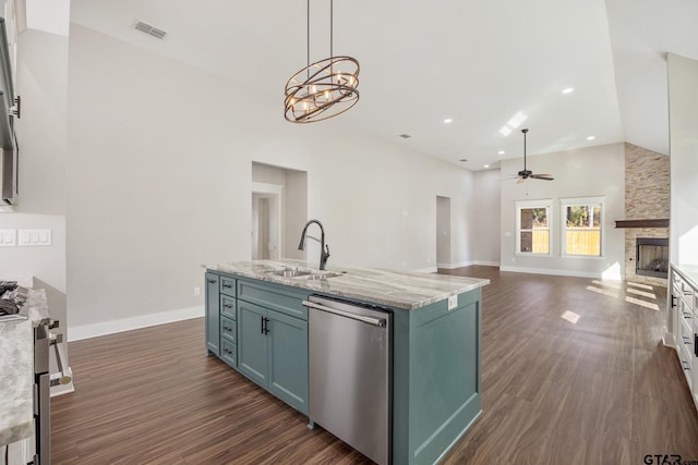 kitchen featuring pendant lighting, dark wood-type flooring, sink, a fireplace, and stainless steel appliances