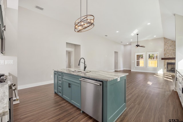 9161 Cave Branch Cv, Tyler, TX 75703 - kitchen with dishwasher, a sink, ceiling fan, dark wood-type flooring, and a stone fireplace