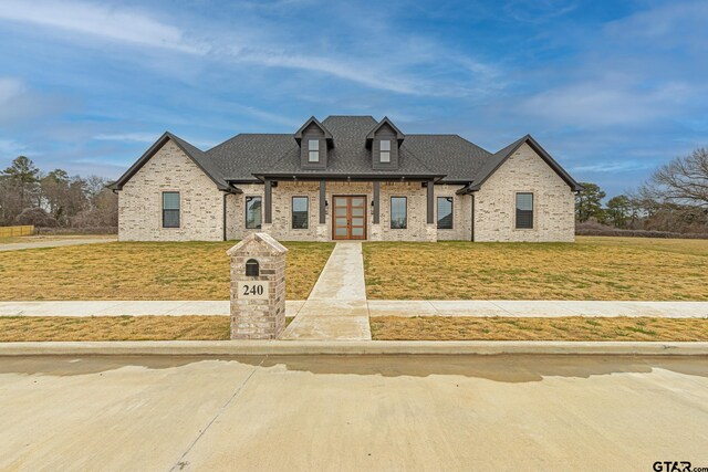 french country home with a front lawn