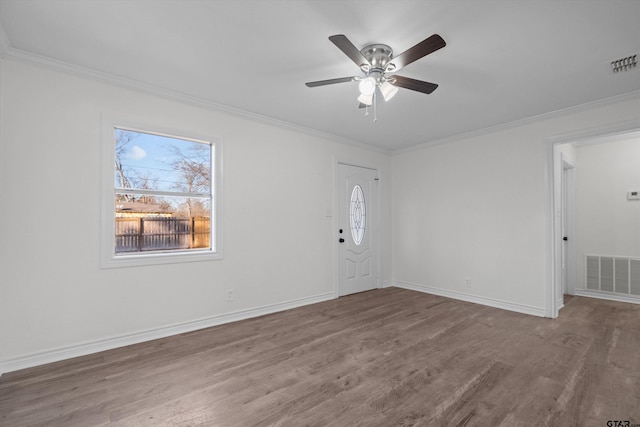 foyer entrance featuring ceiling fan, hardwood / wood-style floors, and crown molding