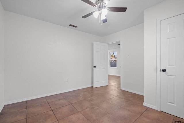 unfurnished room featuring ceiling fan and tile patterned floors