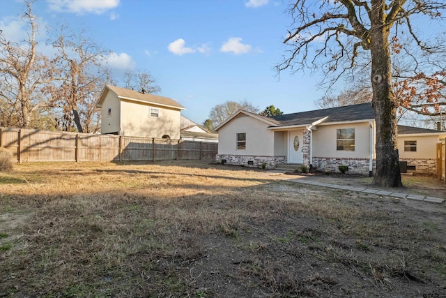 rear view of property featuring a lawn