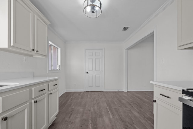 kitchen featuring white cabinets, light wood-type flooring, range with electric stovetop, and ornamental molding