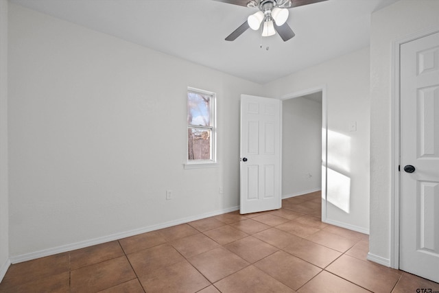 tiled empty room with ceiling fan