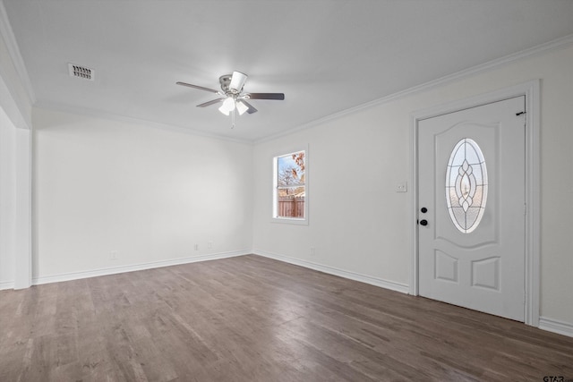 foyer with ceiling fan, dark wood-type flooring, and ornamental molding