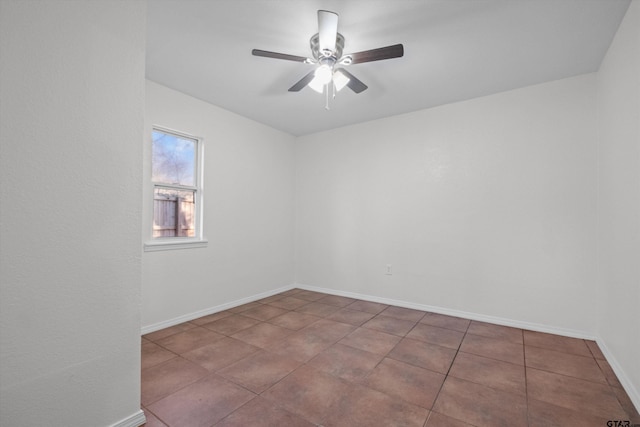 empty room featuring ceiling fan and tile patterned flooring