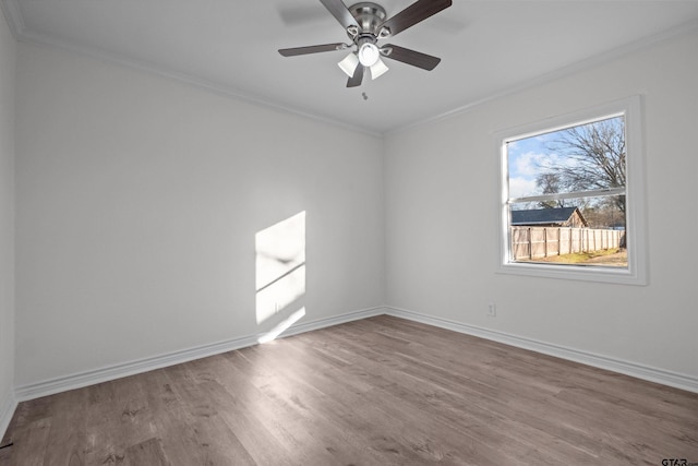 unfurnished room with ceiling fan, wood-type flooring, and crown molding