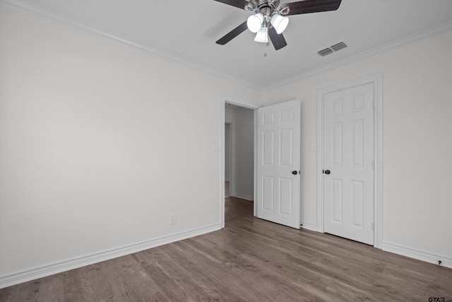 unfurnished bedroom featuring ceiling fan, crown molding, and hardwood / wood-style floors