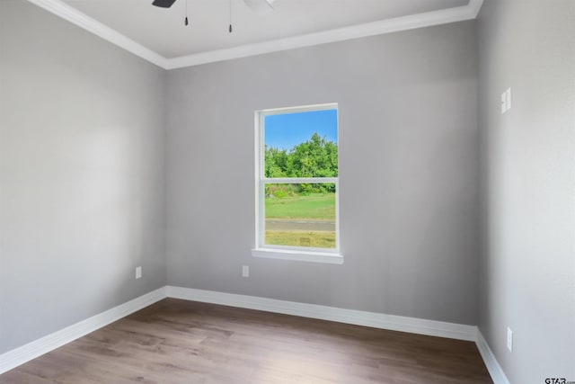 spare room with hardwood / wood-style flooring, ceiling fan, and crown molding