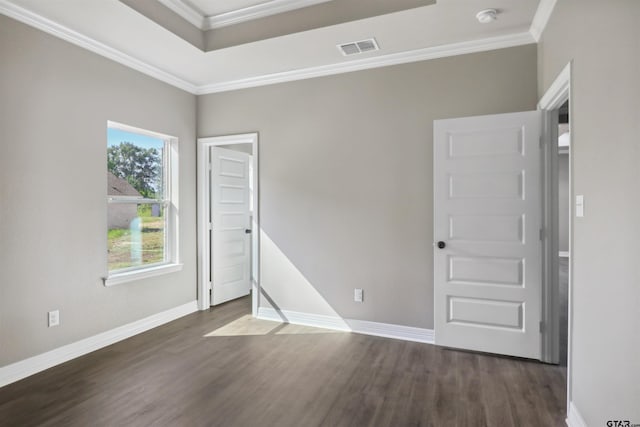 empty room with ornamental molding and dark hardwood / wood-style floors