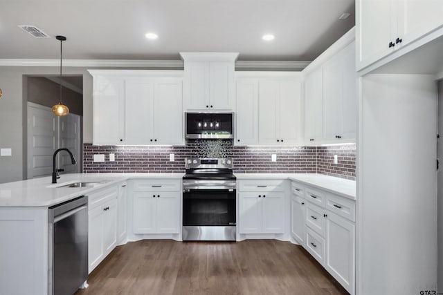 kitchen featuring white cabinetry, sink, pendant lighting, and appliances with stainless steel finishes