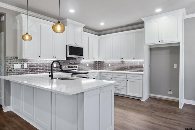 kitchen featuring ornamental molding, stainless steel appliances, white cabinetry, dark hardwood / wood-style flooring, and pendant lighting