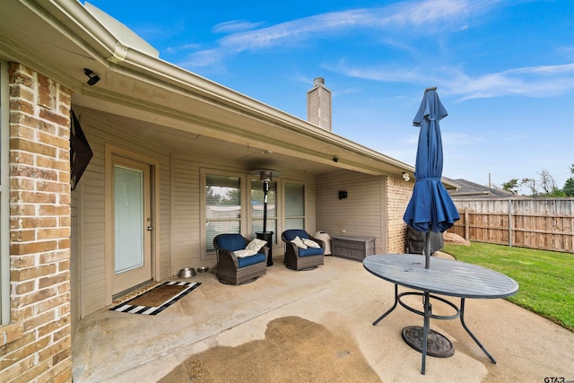 view of patio / terrace featuring fence