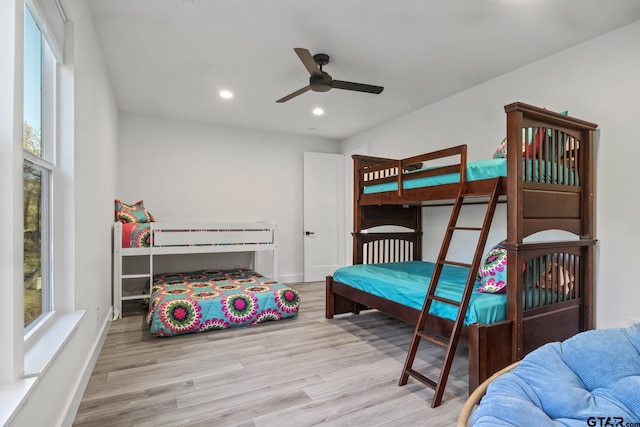 bedroom with ceiling fan and light wood-type flooring