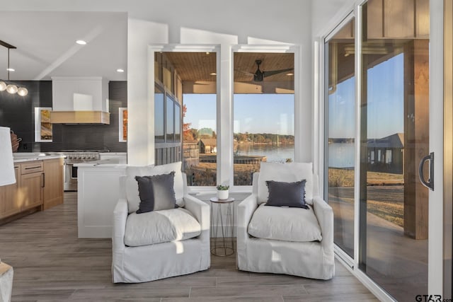 sitting room with wood-type flooring and a water view