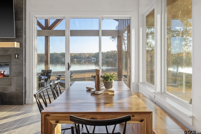 sunroom / solarium featuring a water view