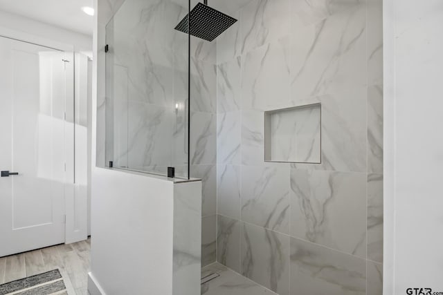 bathroom with a tile shower