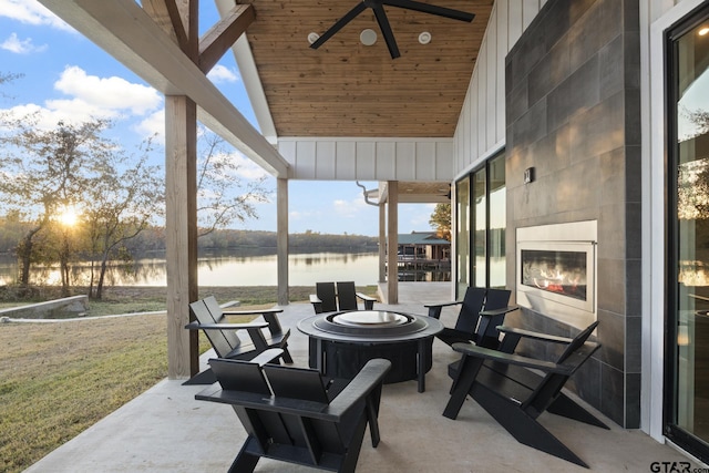 view of patio / terrace featuring a water view and ceiling fan