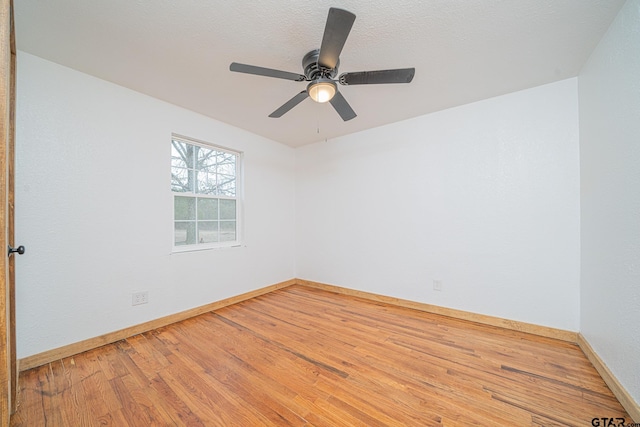 empty room featuring hardwood / wood-style floors, a textured ceiling, and ceiling fan