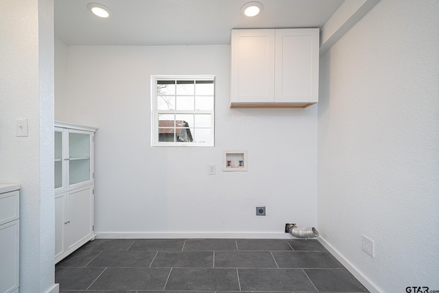 laundry area with cabinets, hookup for an electric dryer, hookup for a washing machine, and dark tile patterned floors