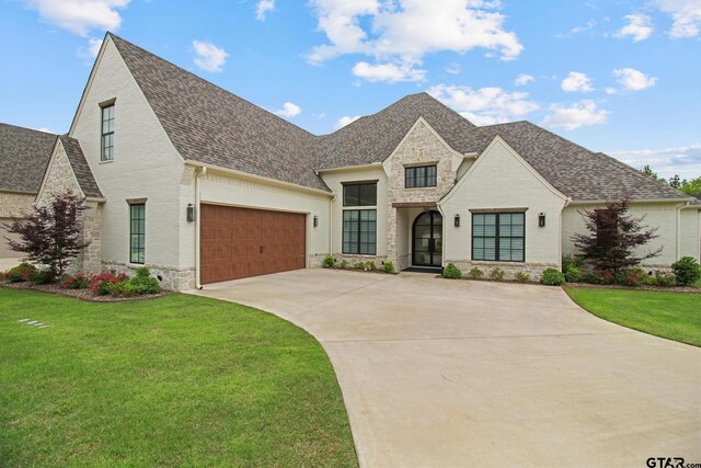 3116 Forest Ridge Cv, Tyler, TX 75703 - french country inspired facade with a shingled roof, concrete driveway, and a front lawn