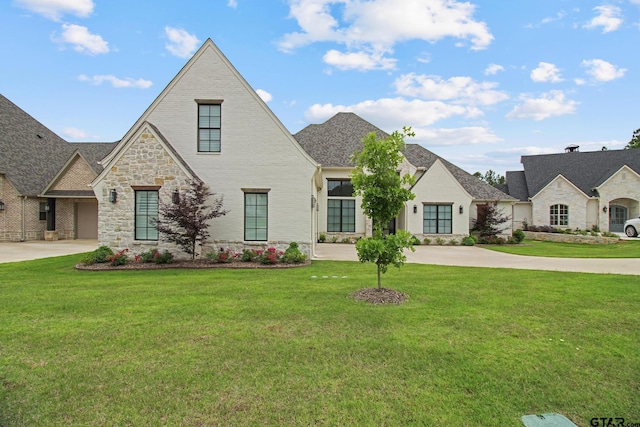 3116 Forest Ridge Cv, Tyler, TX 75703 - french country style house with stone siding, a front lawn, and driveway